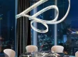 Crystal ribbon chandelier adorns the dining table in a fine dining restaurant