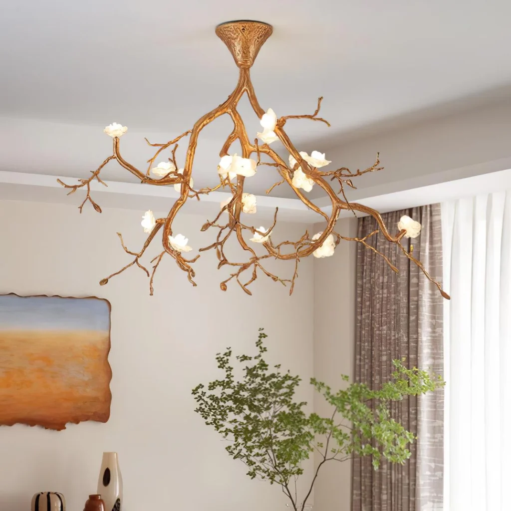 Gold branch chandelier with alabaster flower lights, in a room with art and greenery